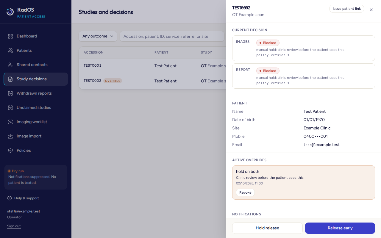 Active override on TEST0002, a hold on both images and report, with a Revoke button.